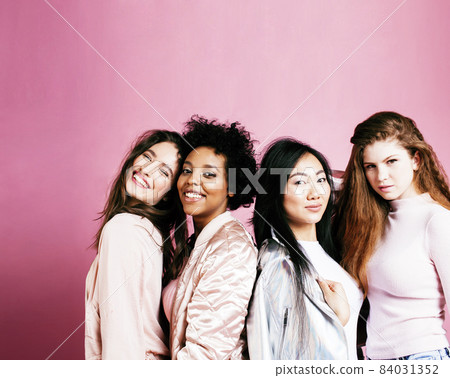 different nation girls with diversuty in skin, hair. Asian, scandinavian, african american cheerful emotional posing on pink background, woman day celebration, lifestyle people concept different nation girls with diversuty in skin, hair. Asian, scandinavian, african american cheerful emotional posing on pink background, woman day celebration, lifestyle people concept 84031352