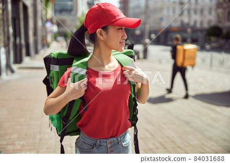Delivery lady working outdoors during coronavirus pandemic Delivery lady working outdoors during coronavirus pandemic 84031688