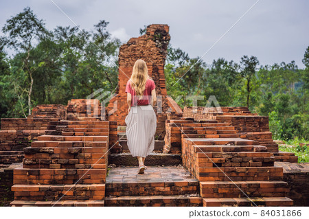 Woman tourist in Temple ruin of the My Son complex, Vietnam. Vietnam opens to tourists again after quarantine Coronovirus COVID 19 84031866