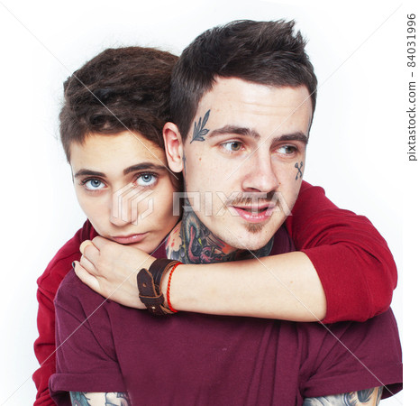 Young couple together. guy with tattoo, girlfriend wearing dreadlocks having fun on white background Young couple together. guy with tattoo, girlfriend wearing dreadlocks having fun on white background 84031996