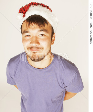 funy exotical asian Santa claus in new years red hat smiling funy exotical asian Santa claus in new years red hat smiling 84031998
