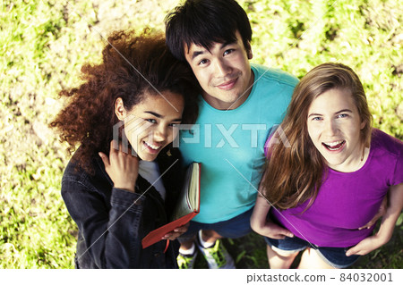 cute group of teenages at the building of university with books huggings, diversity nations, having lunch 84032001