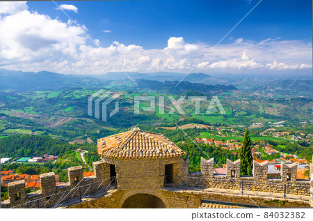 Aerial top panoramic view landscape with valley, green hills, fields, villages of Republic San Marino 84032382