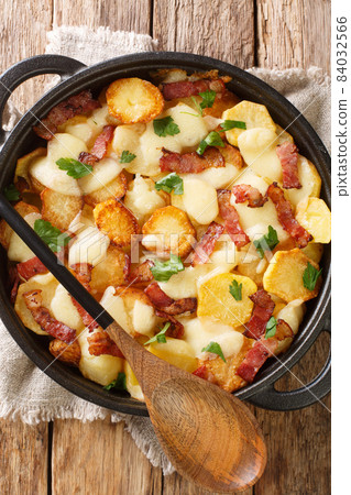 Truffade is a dish traditionally associated with Auvergne in France close up in the pan. Vertical top view 84032566