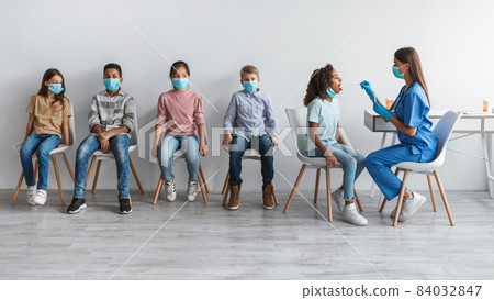 Medical Worker Testing Multiethnic Kids Group For Coronavirus, Gray Background Medical Worker Testing Multiethnic Kids Group For Coronavirus, Gray Background 84032847