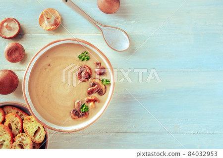 Mushroom soup with various mushrooms and toasted bread, overhead shot Mushroom soup with various mushrooms and toasted bread, overhead shot 84032953