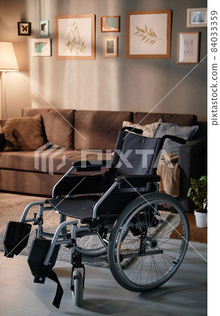 Image of empty wheelchair standing in the living room at home Image of empty wheelchair standing in the living room at home 84033359