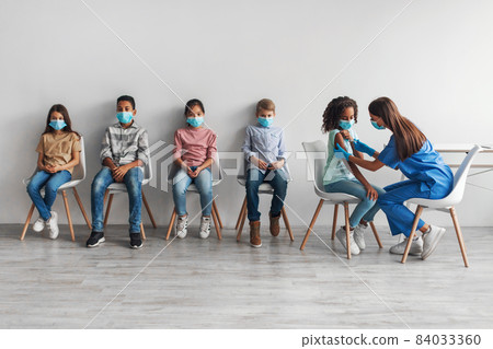 Nurse Injecting Antiviral Vaccine, Vaccinating Black Girl Over Gray Background 84033360