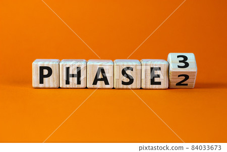 Time for Phase 3. Turned a cube and changed the word 'Phase 2' to 'Phase 3'. Beautiful orange background. Business concept. Copy space. Time for Phase 3. Turned a cube and changed the word 'Phase 2' to 'Phase 3'. Beautiful orange background. Business concept. Copy space. 84033673