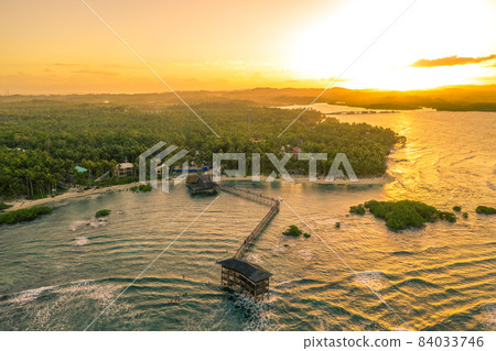 Sunset at Cloud Nine Surfing Area, Siargao Island, Philippines. Aerial Drone shot. Sunset at Cloud Nine Surfing Area, Siargao Island, Philippines. Aerial Drone shot. 84033746