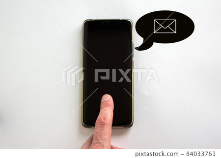Man's finger unlocks a smartphone with a finger on the white background. Sign of message. 84033761