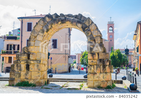 Ruins of ancient stone arch Porta Montanara Gate and Parrocchia di San Gaudenzo church 84035242
