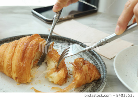 Freshly baked croissant shiny in the coffee cafe Freshly baked croissant shiny in the coffee cafe 84035533
