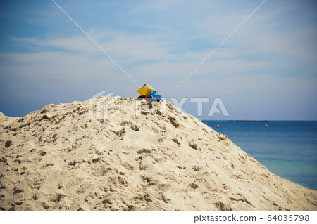Toy truck stuck on beach sand hill top Toy truck stuck on beach sand hill top 84035798