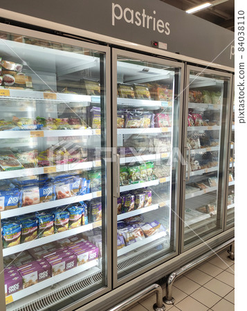 KUALA LUMPUR, MALAYSIA - JUNE 21, 2021: The frozen pastries are packaged in commercial packaging and displayed in a chiller box inside the supermarket. Sorted by brand and labeled with a price tag. 84038110