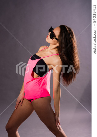Happy beautiful girl dancing and celebrating standing in full length, isolated on studio background 84039412