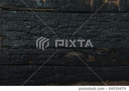 Burnt wooden Board texture. Burned scratched hardwood surface. Smoking wood plank background. Burned wooden grunge texture Burnt wooden Board texture. Burned scratched hardwood surface. Smoking wood plank background. Burned wooden grunge texture 84039474