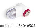 Lint remover on a white background. Electric lint remover close-up on a white background. 84040508