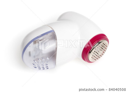Lint remover on a white background. Electric lint remover close-up on a white background. 84040508