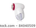 Lint remover on a white background. Electric lint remover close-up on a white background. 84040509
