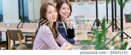 Young woman in shared office Young woman in shared office 84041141