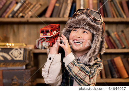 Girl playing with toys Vintage hat pilot Girl playing with toys Vintage hat pilot 84044017