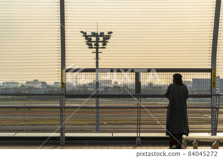 Airport scenery Toyonaka City, Osaka Prefecture, silhouette of a woman watching the sunset and an airplane Airport scenery Toyonaka City, Osaka Prefecture, silhouette of a woman watching the sunset and an airplane 84045272