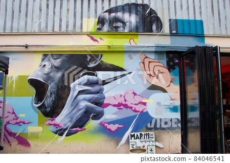 London urban street art with chimpanzee on industrial warehouse 84046541