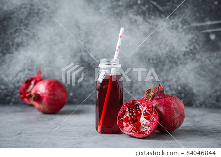 Pomegranate juice in bottle and fruit Pomegranate juice in bottle and fruit 84046844