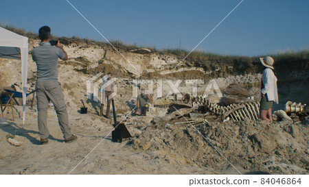 Archaeologists working on digging site 84046864