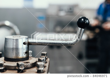 This is metal handle of lathe close-up. Part of industrial equipment for metalworking. Genuine 84046971