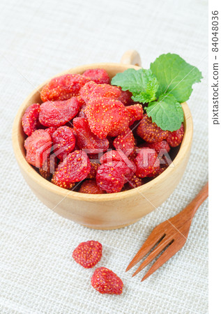 Dried Strawberries in wooden bowl. Dried Strawberries in wooden bowl. 84048036