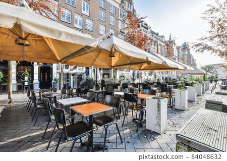 Beautiful street with tables and benches for dinner 84048632