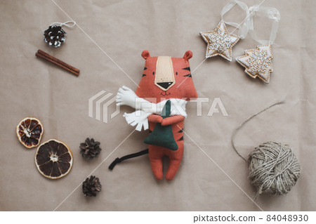 funny tiger toy, symbol of new 2022, a gift and decorations. Christmas, winter, new year concept. Flat lay, top view funny tiger toy, symbol of new 2022, a gift and decorations. Christmas, winter, new year concept. Flat lay, top view 84048930