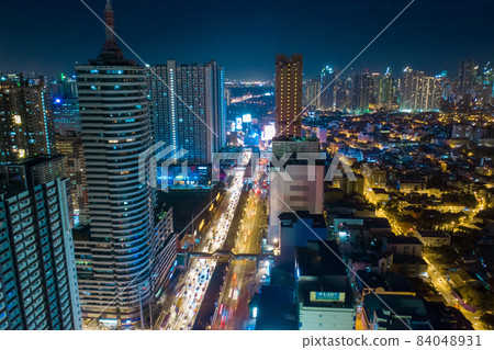 Aerial drone shot a Manila night Skyline. Elevated, night view of Makati, the business district of 84048931