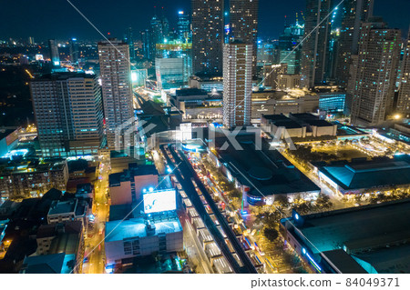 Aerial drone shot a Manila night Skyline. Elevated, night view of Makati, the business district of Aerial drone shot a Manila night Skyline. Elevated, night view of Makati, the business district of 84049371