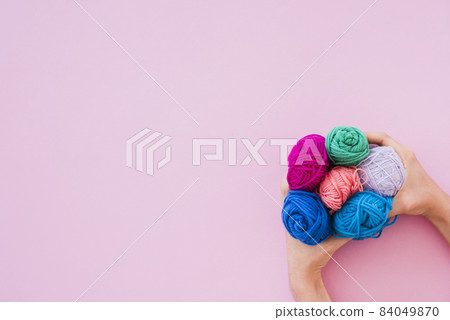 elevated view hand holding colorful wool pink background 2. High quality beautiful photo concept 84049870