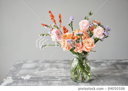 Finished flower arrangement in a vase for home. Flowers bunch, set for interior. Fresh cut flowers for decoration home. European floral shop. Delivery fresh cut flower. 84050386