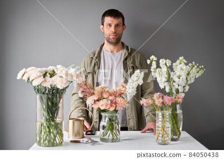 Male florist Step by step installation of flowers in a vase. Flowers bunch, set for home. Fresh cut flowers for decoration home. European floral shop. Delivery fresh cut flower. 84050438