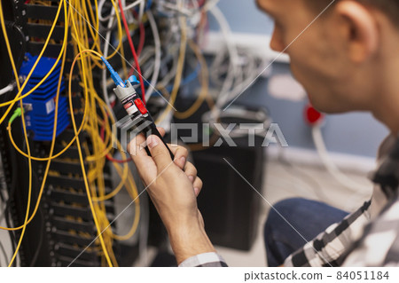 engineer man testing optical fiber. High quality beautiful photo concept engineer man testing optical fiber. High quality beautiful photo concept 84051184