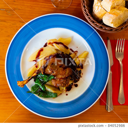 Duck leg confit in port with pear chutney Duck leg confit in port with pear chutney 84052986