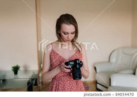 Freelance photographer woman with camera at home office editing photos on a computer Freelance photographer woman with camera at home office editing photos on a computer 84054470