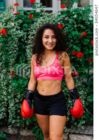 Woman power, self defence concept. Portrait of attractive serious fit boxer, ready for fight Woman power, self defence concept. Portrait of attractive serious fit boxer, ready for fight 84054647