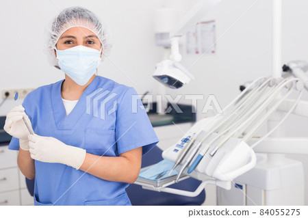Portrait of professional dentist woman in protective face mask Portrait of professional dentist woman in protective face mask 84055275