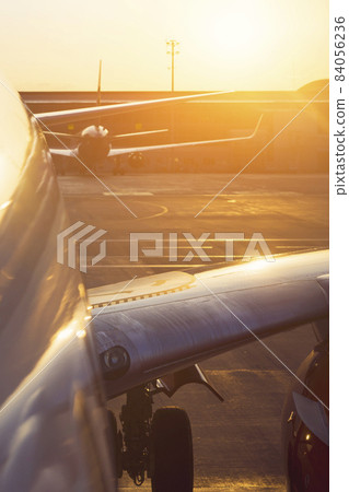 Airplane at sunset on the runway. Airplane at sunset on the runway. 84056236