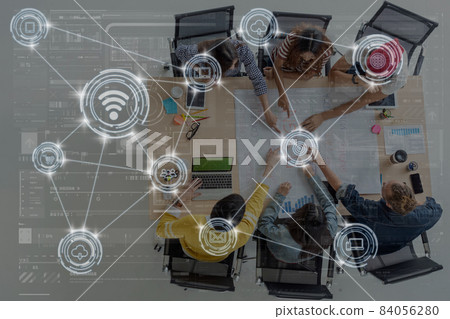 Technology digital virtual screen and Wireless communication connecting over Top view scene of Asian and Multiethnic Business people with brainstorming and pointing to the target in modern workplace 84056280