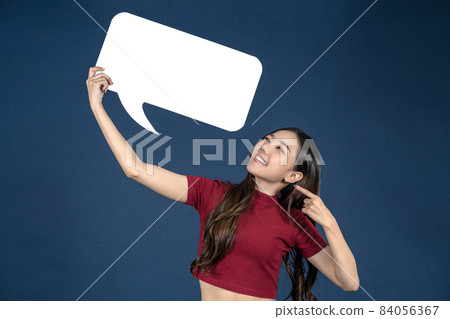 Happy young smiling Asian woman holding copy space empty message bubbles on blue color background, thinking and specking via balloon blank paper, Private opinion for advertisement Concept Happy young smiling Asian woman holding copy space empty message bubbles on blue color background, thinking and specking via balloon blank paper, Private opinion for advertisement Concept 84056367