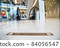 Keep Your Distance Text on the floor before escalator in department store 84056547