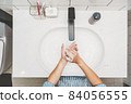 Top view Asian woman hand washing with faucet water in Bathroom at home, Health care of Covid-19 pandemic, cleaning and carefree concept 84056555