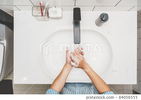 Top view Asian woman hand washing with faucet water in Bathroom at home, Health care of Covid-19 pandemic, cleaning and carefree concept 84056555